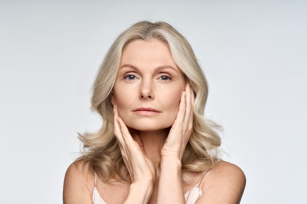 Older woman touching her perfect skin.
